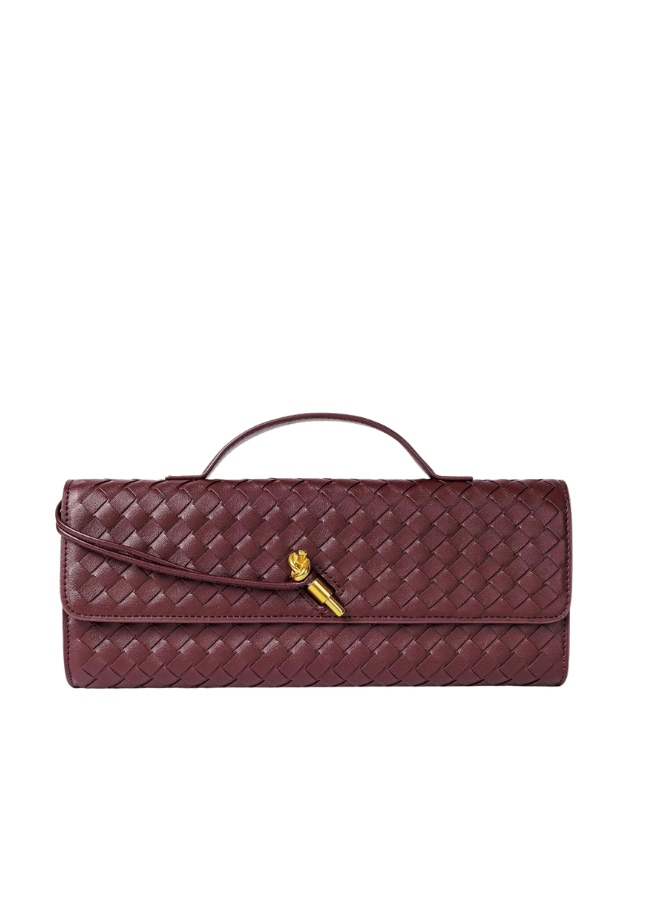 A dark burgundy woven leather clutch bag with a top handle and a small gold-tone lion emblem, shown against a plain white background.