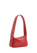 A red faux-leather shoulder bag with silver metal studs and grommets along the strap and sides, shown on a plain white background.